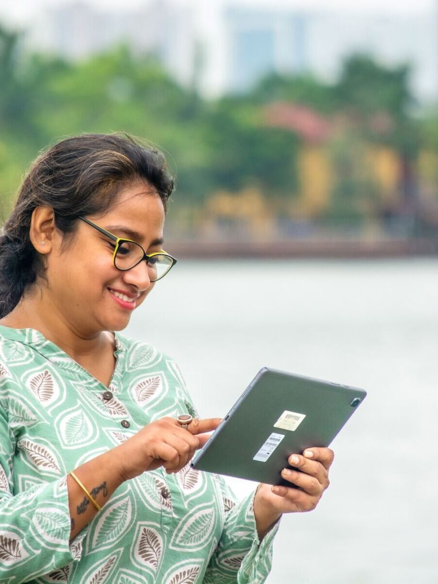 Woman in India reading something on a tablet